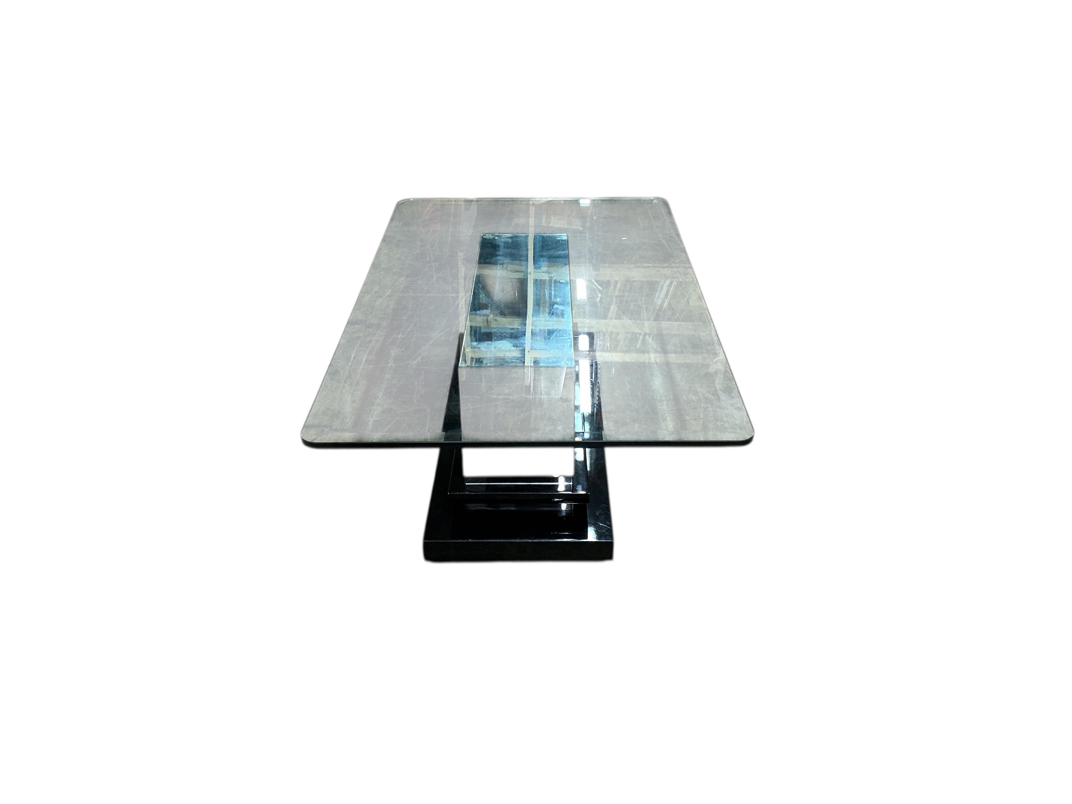 A Contemporary rectangular glass coffee table on mirrored, ebonized plinth base, width 140cm, depth 84cm, height 46cm
